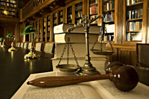 personal injury attorney New York, NY with scales and a gavel in a library